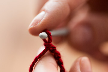 Image showing close up of hands knitting with crochet hook