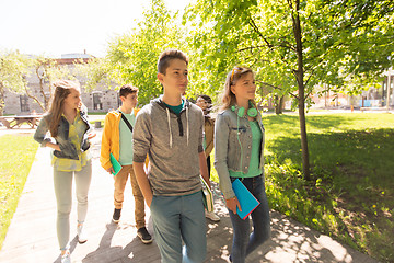 Image showing group of happy teenage students walking outdoors