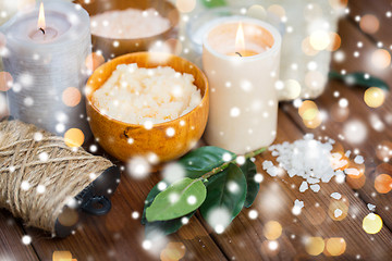 Image showing natural body scrub and candles on wood