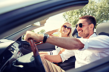 Image showing happy man and woman driving in cabriolet car