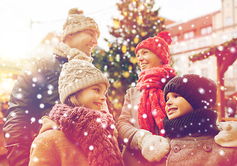 Image showing happy family over city christmas tree and snow