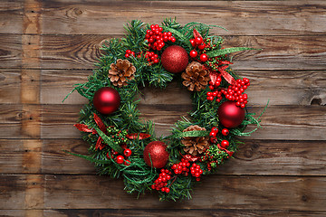 Image showing Christmas wreath on wooden background