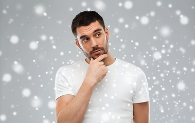 Image showing man thinking over snow background