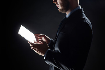 Image showing close up of businessman with transparent tablet pc