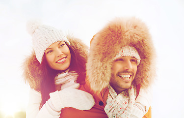 Image showing happy couple having fun over winter background