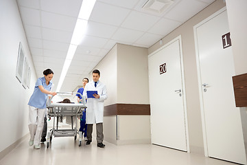 Image showing medics and patient on hospital gurney at emergency