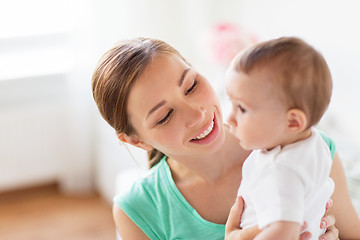 Image showing happy young mother with little baby at home