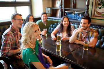 Image showing friends with beer watching football at bar or pub