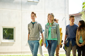 Image showing group of happy teenage students walking outdoors