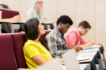 Image showing group of students with notebooks in lecture hall