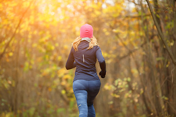 Image showing Slender female running in park