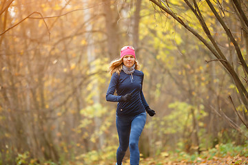 Image showing Running on autumn park sportswoman