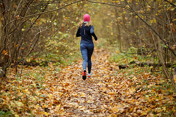 Image showing Young woman jogging in morning