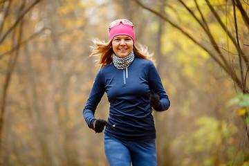 Image showing Young woman jogging in morning