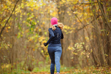 Image showing Slender girl running in park