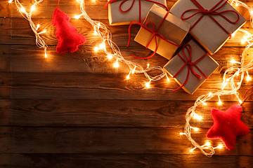Image showing Christmas presents on wooden background