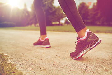 Image showing close up of woman feet running on track from back