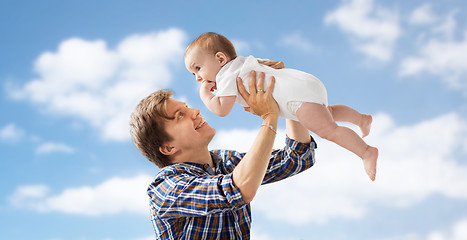 Image showing happy young father playing with baby over blue sky