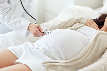 Image showing doctor with stethoscope and pregnant woman