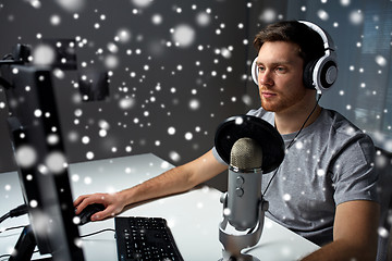 Image showing man in headset playing computer video game at home