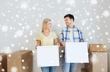 Image showing smiling couple with big boxes moving to new home