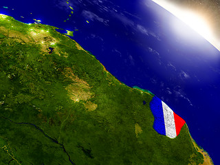 Image showing French Guiana with flag in rising sun