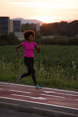 Image showing a young African American woman jogging outdoors