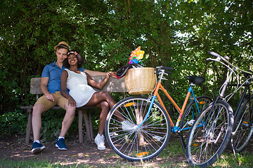 Image showing Young multiethnic couple having a bike ride in nature