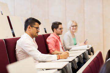 Image showing group of students with notebooks in lecture hall