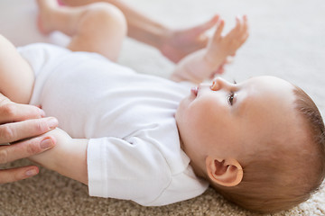 Image showing close up of happy little baby and mother hands