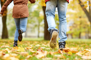 Image showing young couple running in autumn park