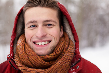 Image showing close up of happy man in winter jacket with hood