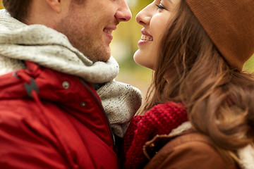 Image showing close up of happy young couple kissing outdoors