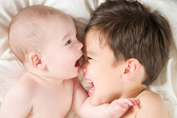 Image showing Mixed Race Chinese and Caucasian Baby Brothers Having Fun Laying