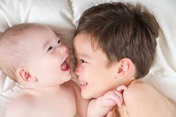 Image showing Mixed Race Chinese and Caucasian Baby Brothers Having Fun Laying