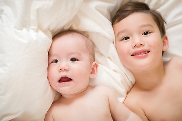 Image showing Mixed Race Chinese and Caucasian Baby Brothers Having Fun Laying