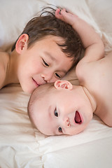 Image showing Mixed Race Chinese and Caucasian Baby Brothers Having Fun Laying