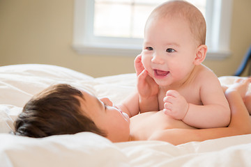 Image showing Mixed Race Chinese and Caucasian Baby Brothers Having Fun Laying