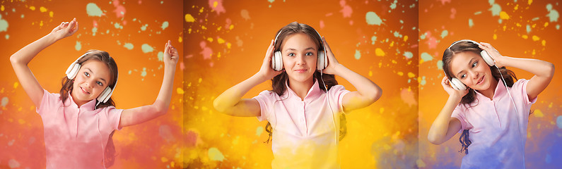 Image showing The cute cheerful little girl on orange background