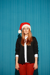 Image showing Surprised christmas girl wearing a santa hat