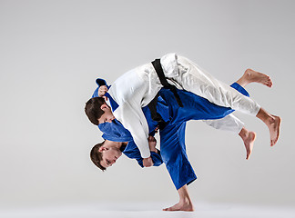 Image showing The two judokas fighters fighting men