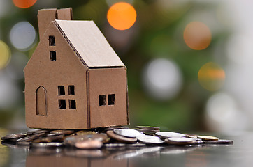 Image showing Model of house with coins on wooden table