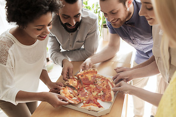 Image showing happy business team eating pizza in office