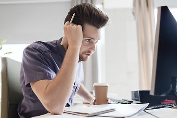 Image showing creative male office worker with coffee thinking