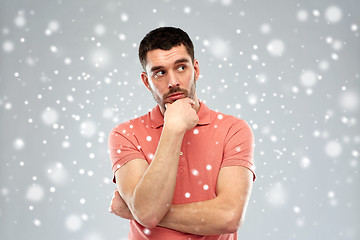 Image showing man thinking over snow background