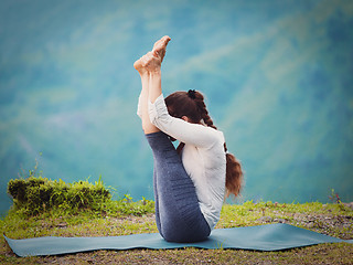 Image showing Woman practices yoga asana Urdhva mukha paschimottanasana 