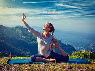 Image showing Sorty fit woman doing yoga asana outdoors in mountains