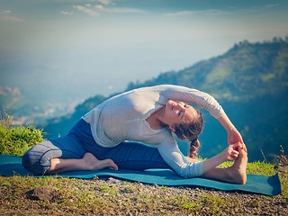 Image showing Young sporty fit woman doing Hatha Yoga asana