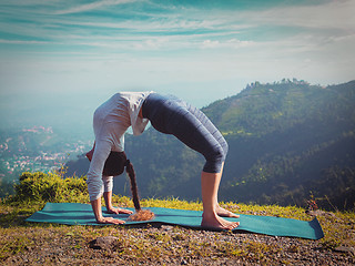 Image showing Woman doing Ashtanga Vinyasa Yoga asana Urdhva Dhanurasana