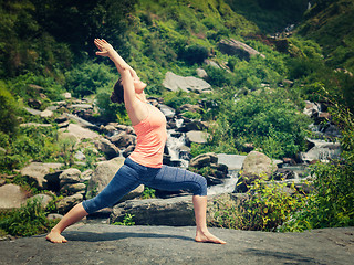 Image showing Woman doing Ashtanga Vinyasa Yoga asana Virabhadrasana 1 Warrior